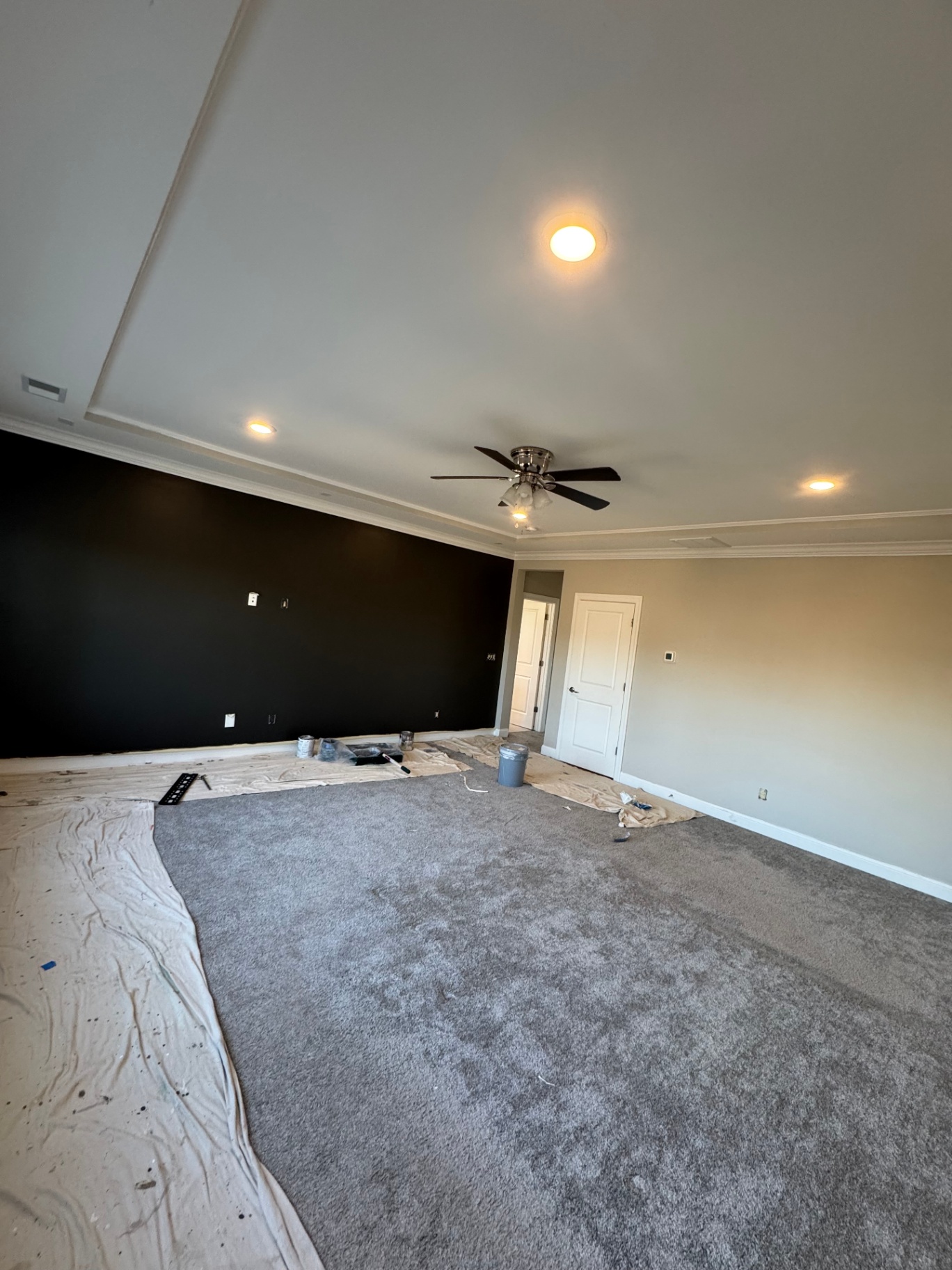 Living room with dramatic black accent wall and warm neutral walls