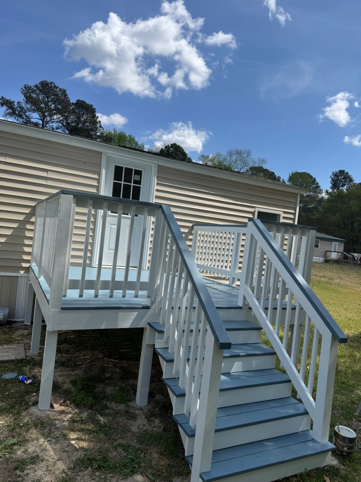 Freshly painted white and blue exterior deck and stairs