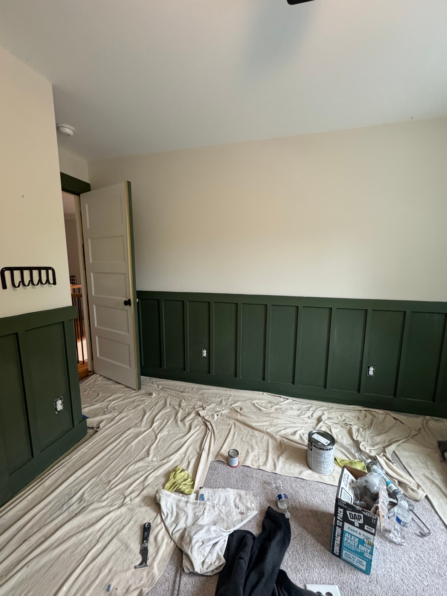 Two-tone bedroom with forest green board-and-batten wainscoting