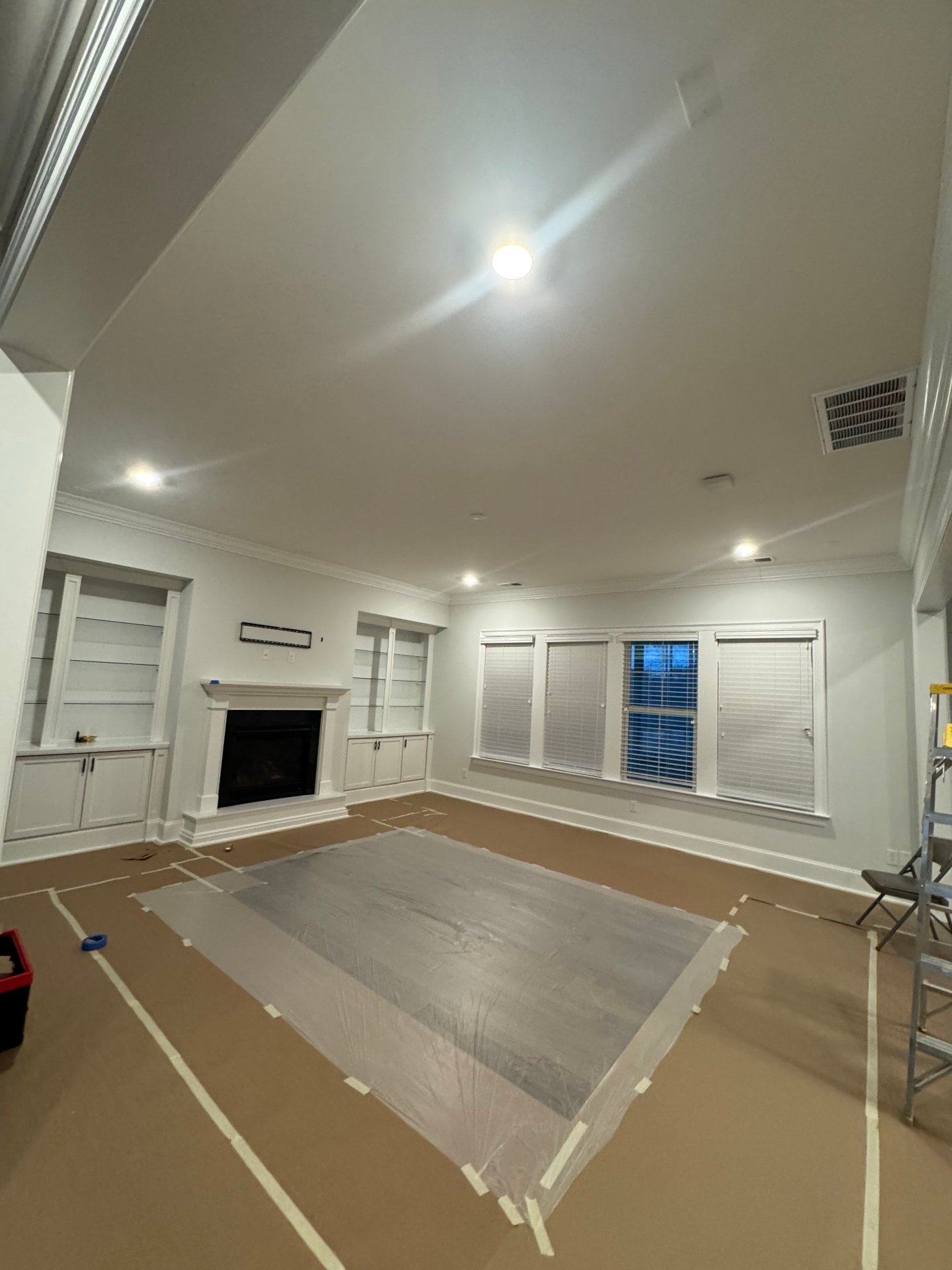 Freshly painted living room with white built-ins and fireplace